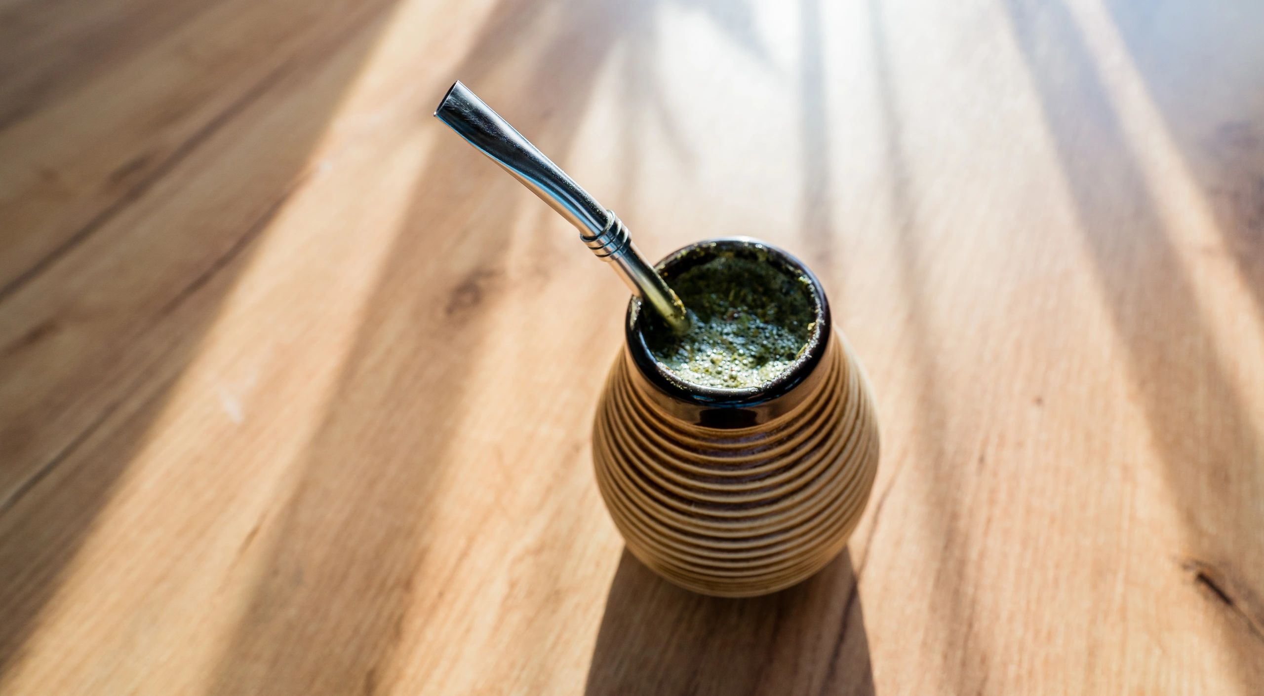 Yerba mate gourd and bombilla on an indoor table