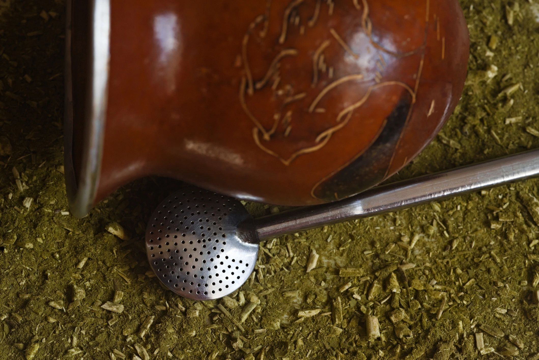 Traditional yerba mate gourd with bombilla on a table