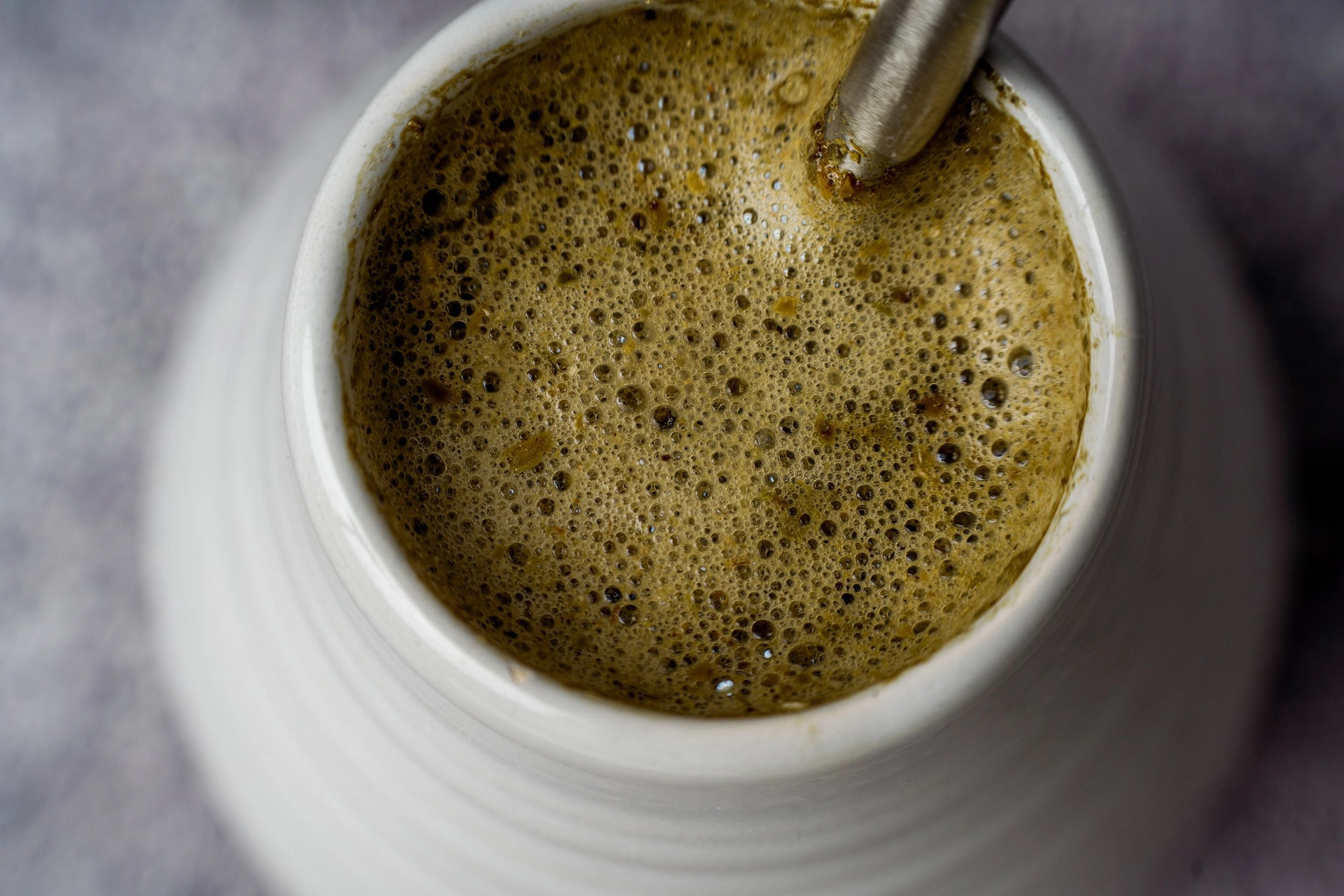 Macro detail of yerba mate foam surface with a bombilla